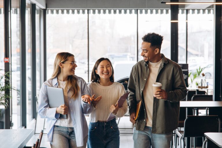 Diverse university students walking and talking in cafeteria