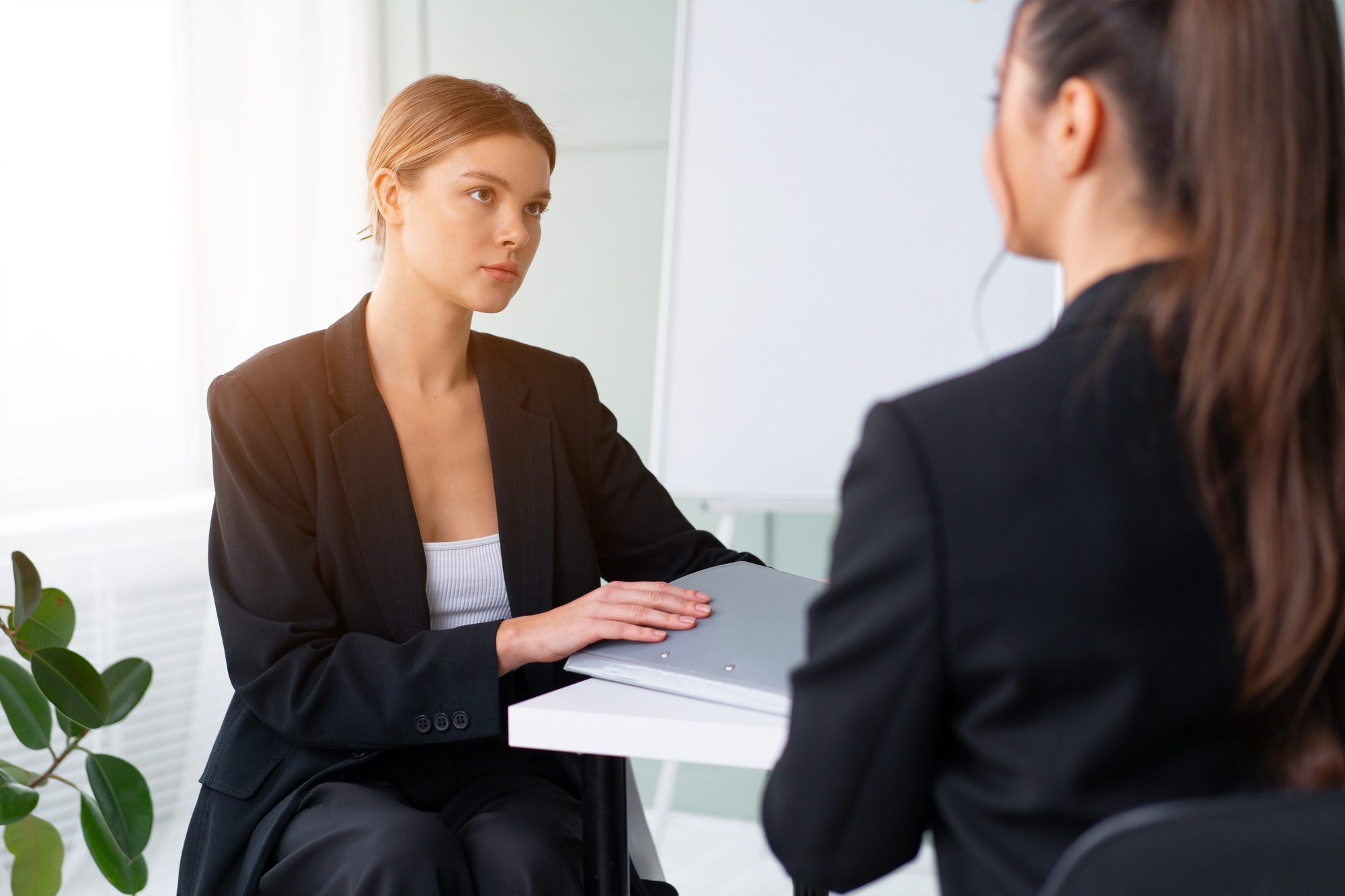 Job interview , Business, career and placement concept. Young blonde woman holding resume